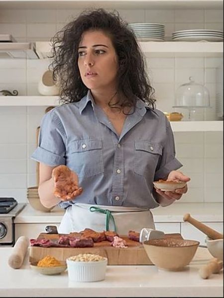 Nadine Malouf in a grey shirt at her kitchen.